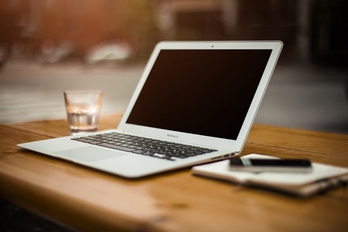 laptop-mobile-phone-and-water-glass-on-wooden-table.jpg