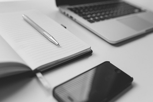 black-and-white-image-of-mobile-phone-and-notebook.jpg