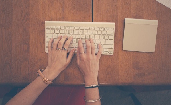 aerial-view-of-womans-hands-typing-on-computer-keyboard.jpg
