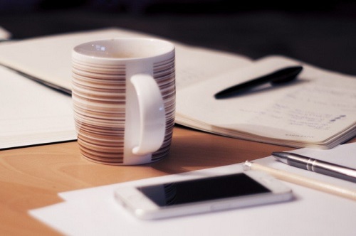 mobile-phone-and-mug-on-office-desk.jpg